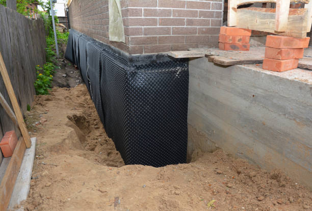 SJ Waterproofing Pros technician performing targeted Wet Basement Repair assessment in Jonesville, KY